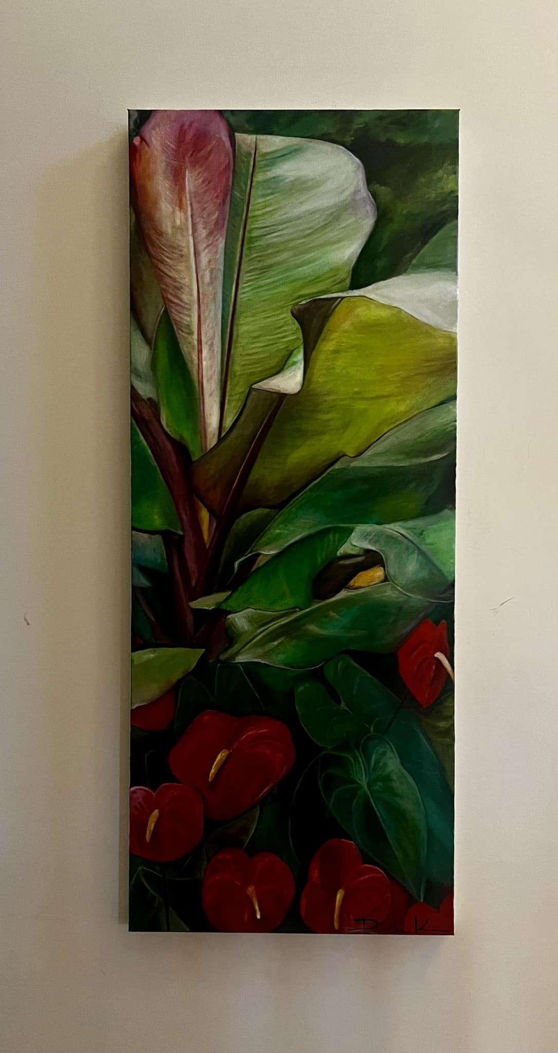 A vertical painting of green leaves and red flowers on a white wall.