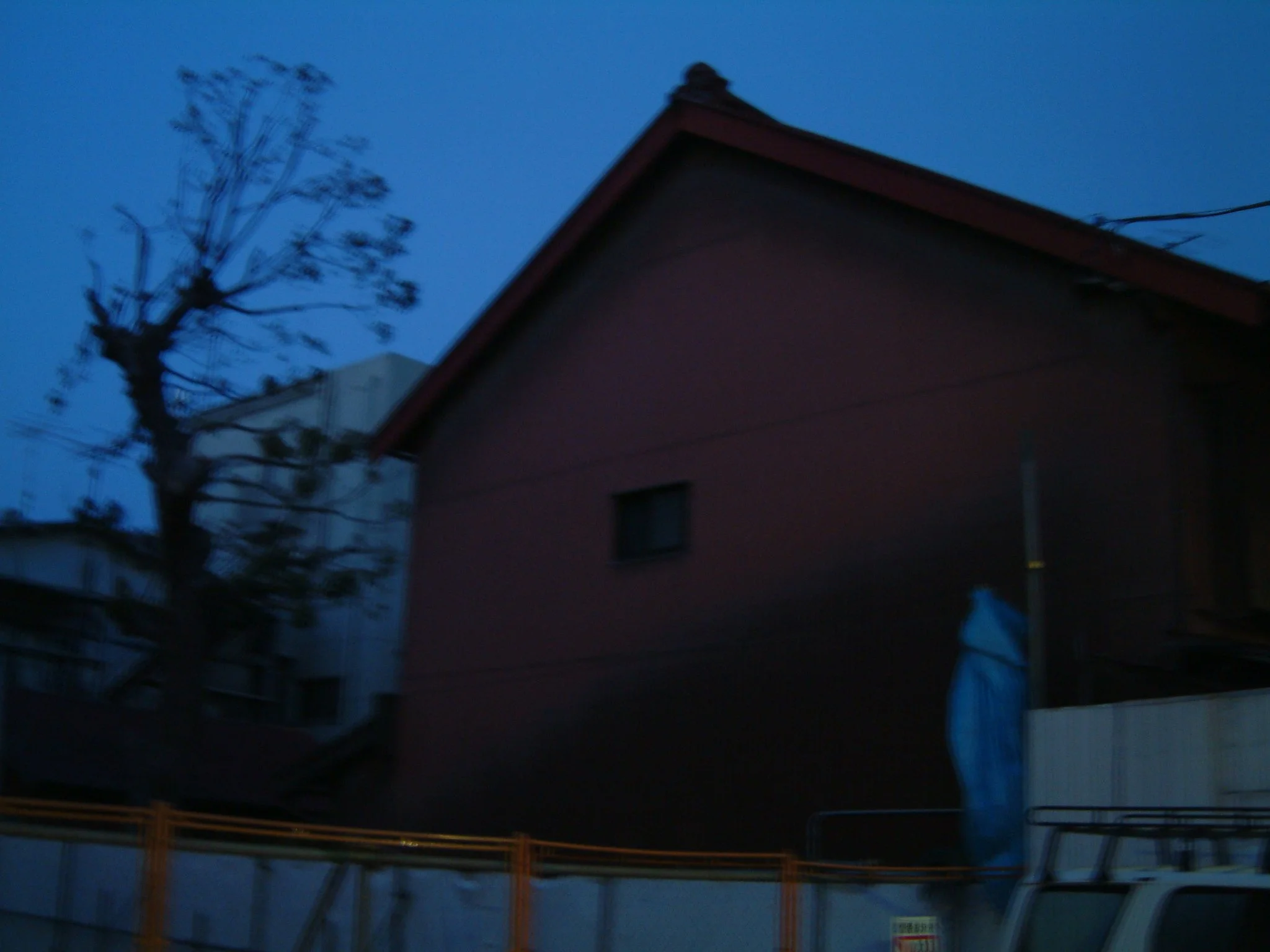 TITLE: Der Blaue Writer; This wintry Tokyo house--red and barn like in the blue light of surrealist time...who lives there? Do I? In another dimension?  A writer, writing...while a fire crackles by my side?