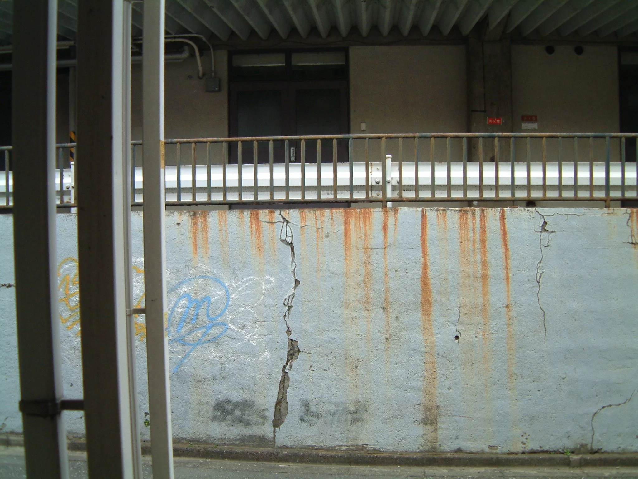 TITLE: Tomigaya Tiger;  Open, sesame.  Well, actually this is Open, Tomigaya...the view from my front door on a Tokyo backstreet.  That wall?  Tiger-striped with rust...what is it holding back? 