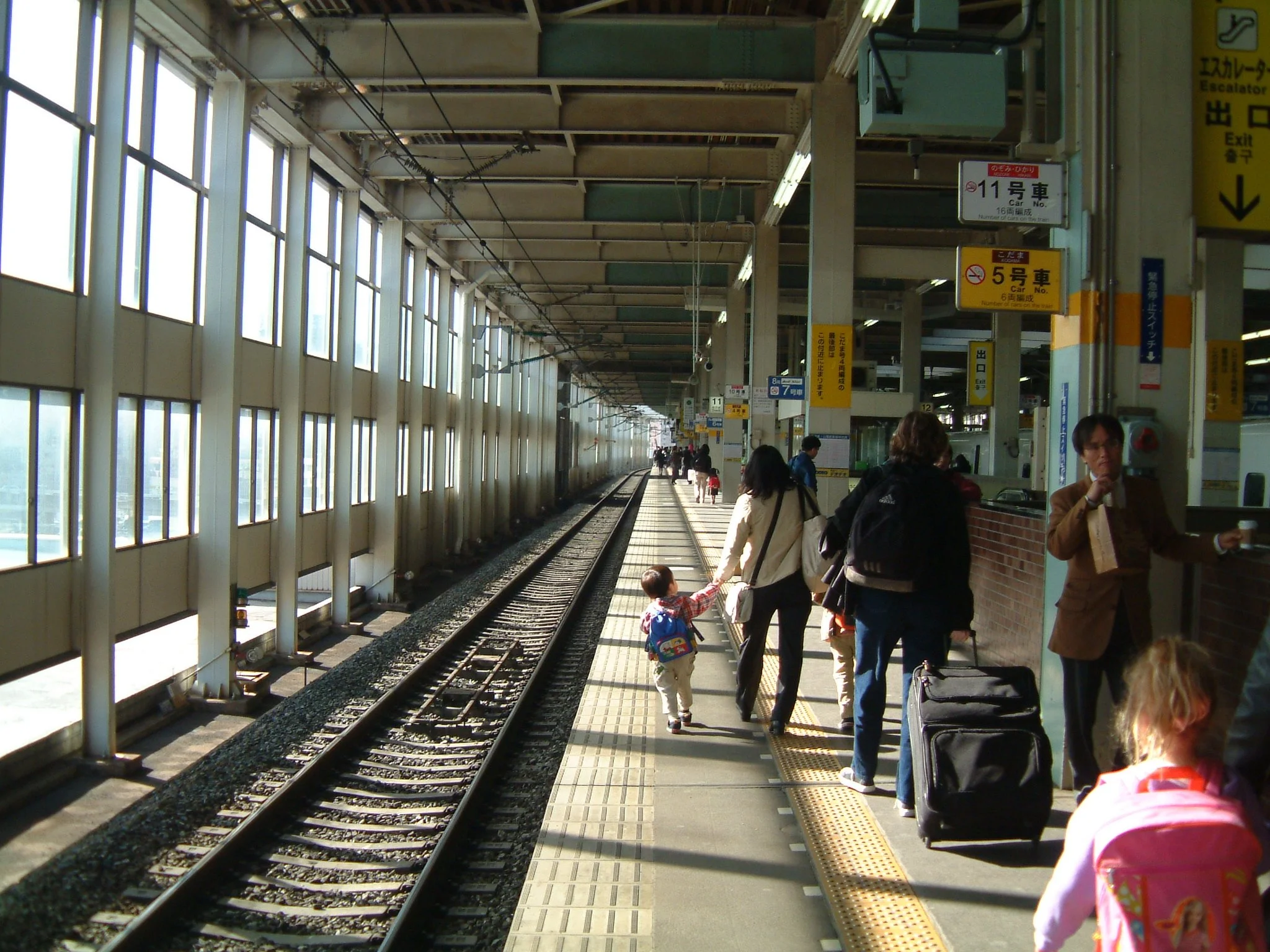 TITLE: Mom, I want to grow up!  This picture shows the literal pull of a child's passion for freedom...notice how the mom is saving the child from the corridor of the tracks... he is not ready.  In some ways, we never are.
