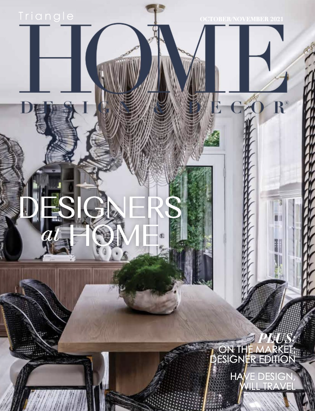 Cover of October/November 2021 issue of Home Decor magazine, featuring a modern dining room with a large chandelier, a wooden dining table, black mesh chairs, and decorated walls with artwork and curtains.