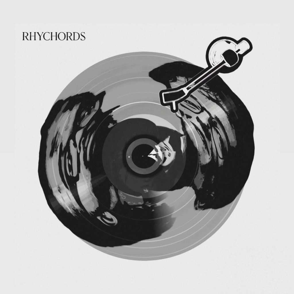 Black and white vinyl record with a stylized dog illustration and a tonearm on a turntable, with the word 'RHYCHORDS' in the top left corner.