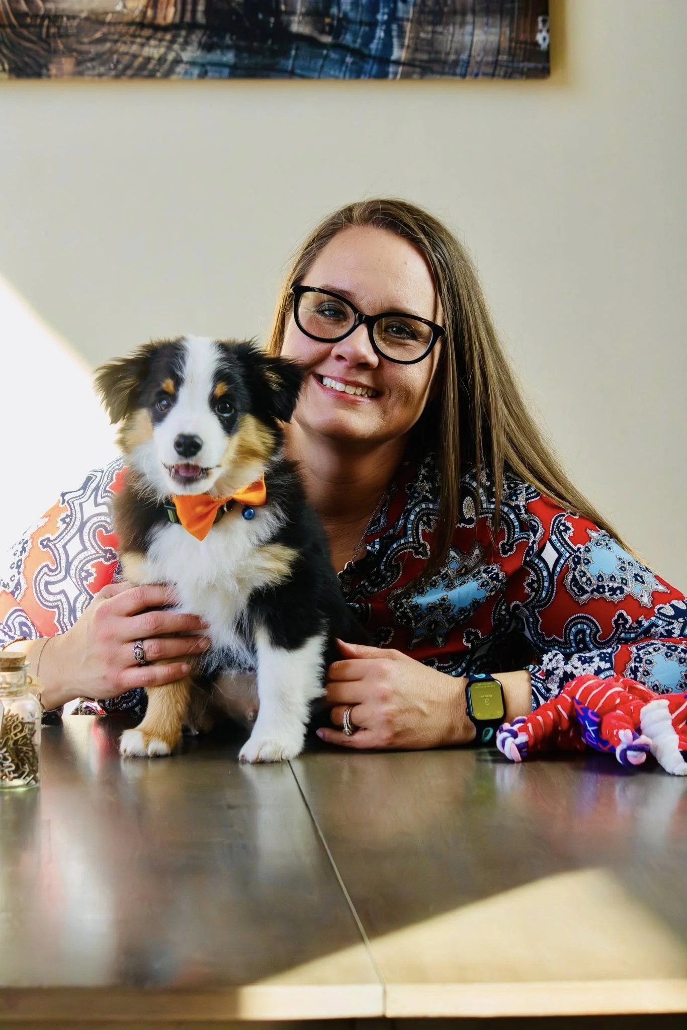 Stacy Reynolds, a therapist in Abilene, TX, sitting with her therapy dog Theodore, offering bold and authentic counseling for BIPP, CPS, and court-mandated clients.