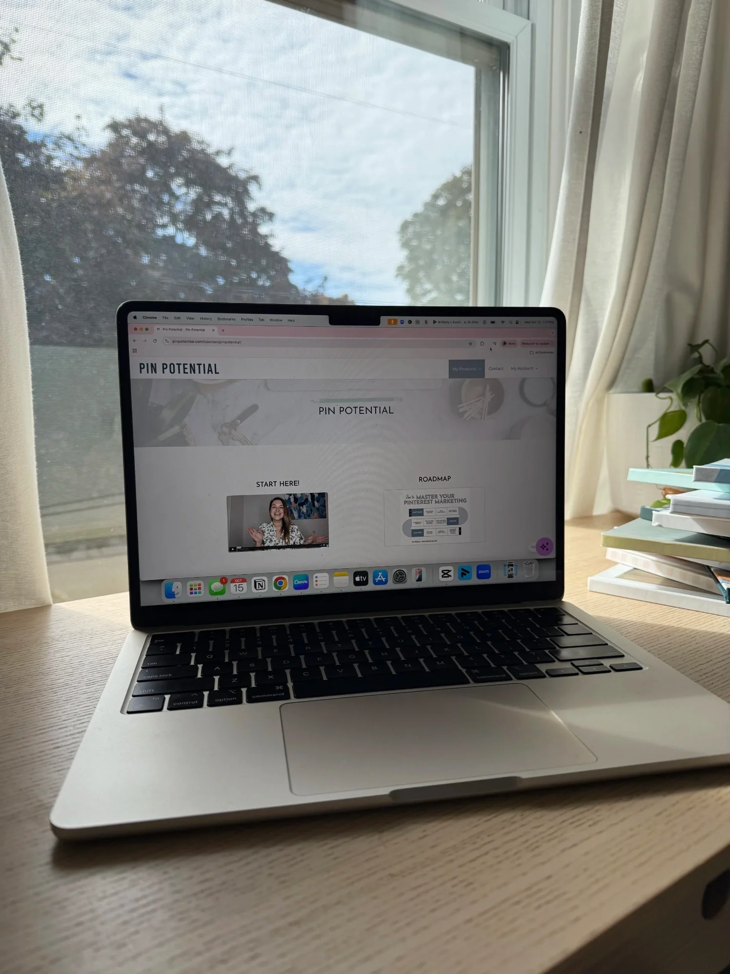 Open MacBook laptop on a wooden desk displaying the Pin Potential website.