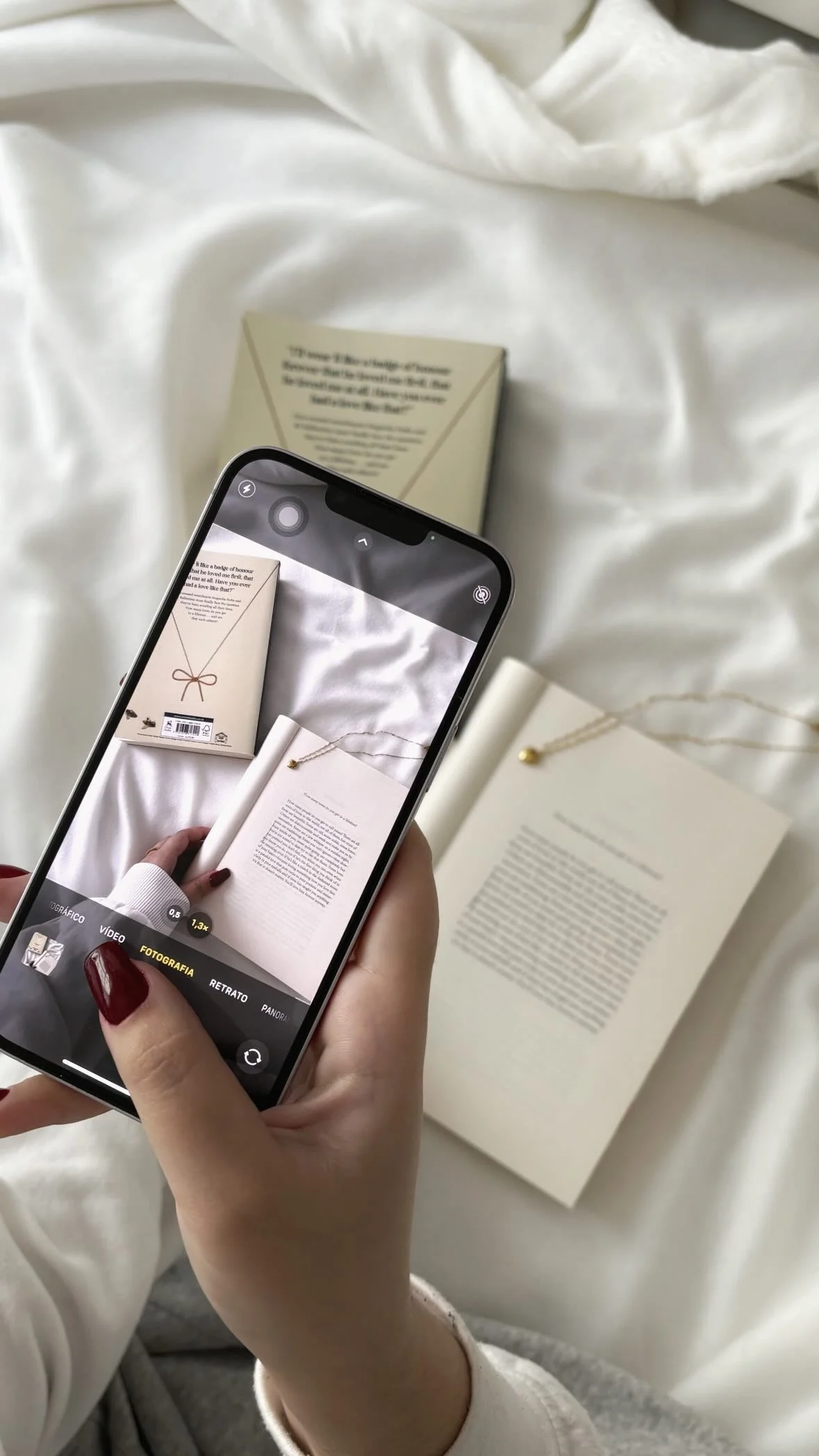 Person holding a purple and pink indigo whipped cream can in a kitchen.