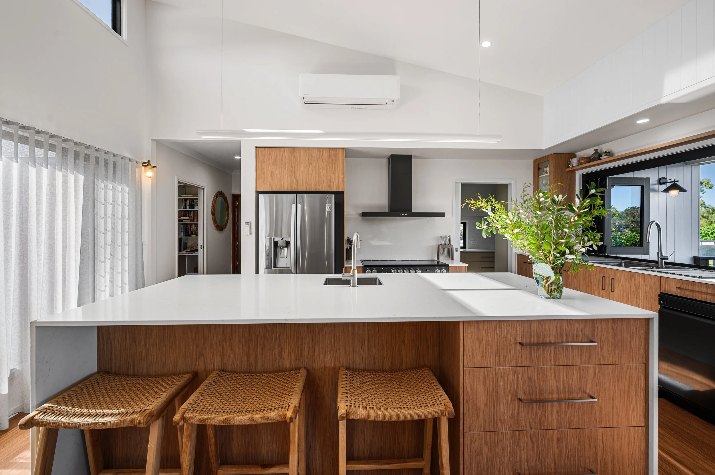 Luxury renovation photography in Bundaberg featuring a high-end modern kitchen with premium finishes, stone benchtops and custom cabinetry.