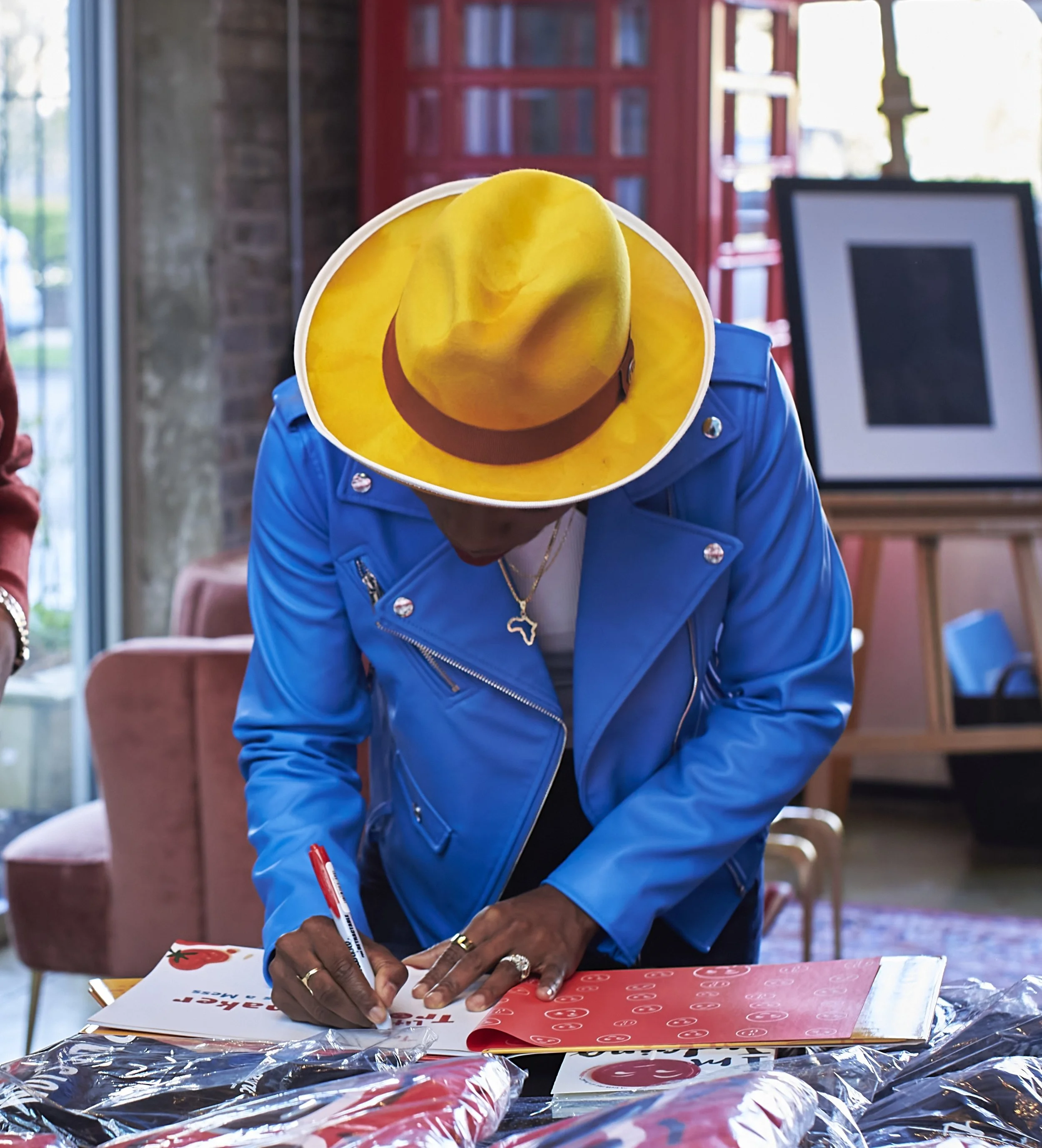 Luvvie signing Little Troublemaker Book