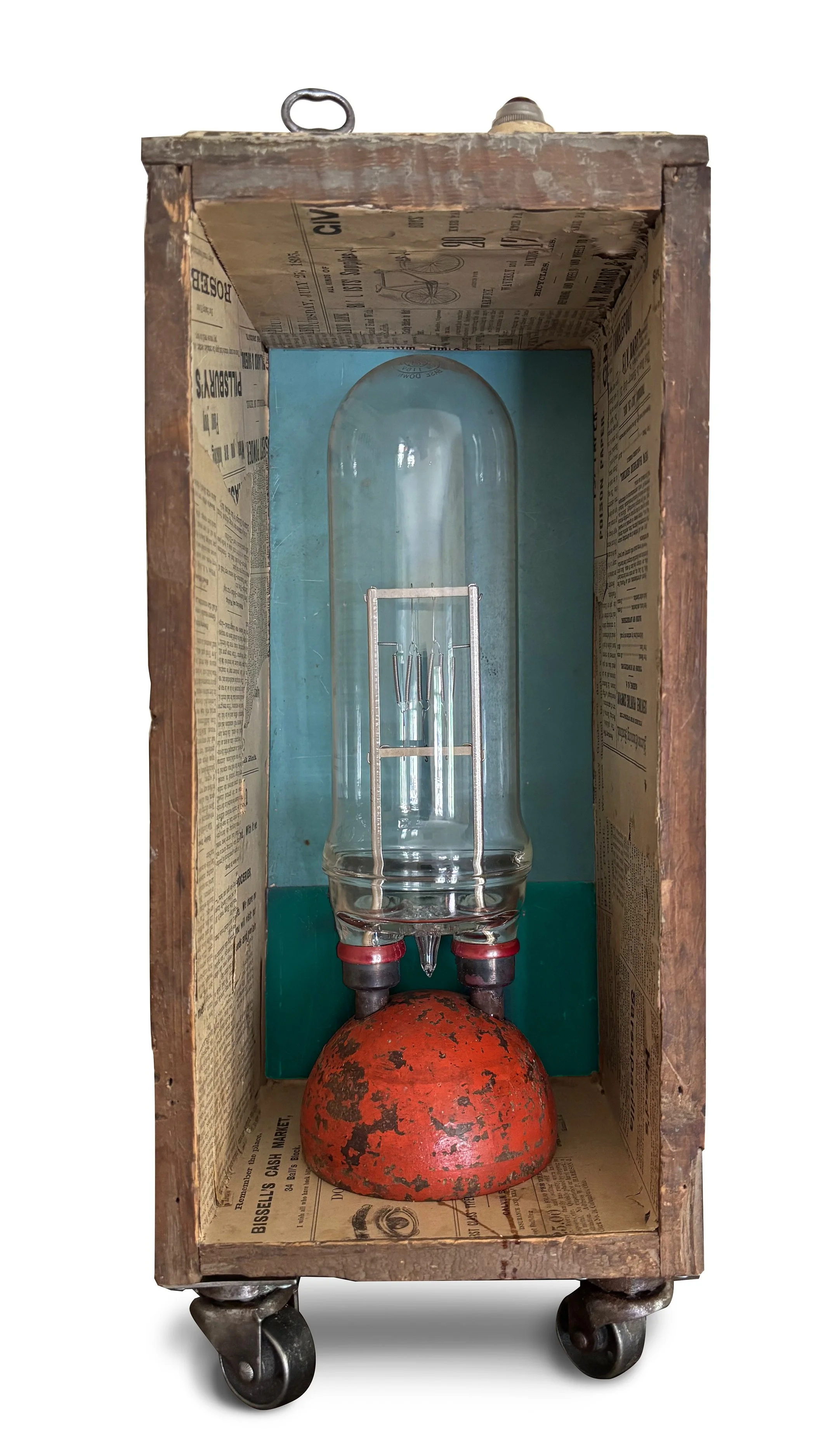 
Big Bad Bulb, 2026 /
Mazda bulb, croquet ball,
wooden box, newsprint, casters /
6 x 12 x 5.5 inches
