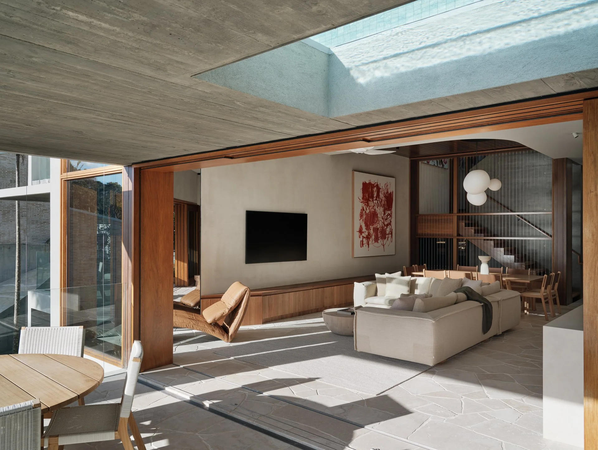 A glass bottom pool reflecting blue skies into the living spaces, don't mind if we do...