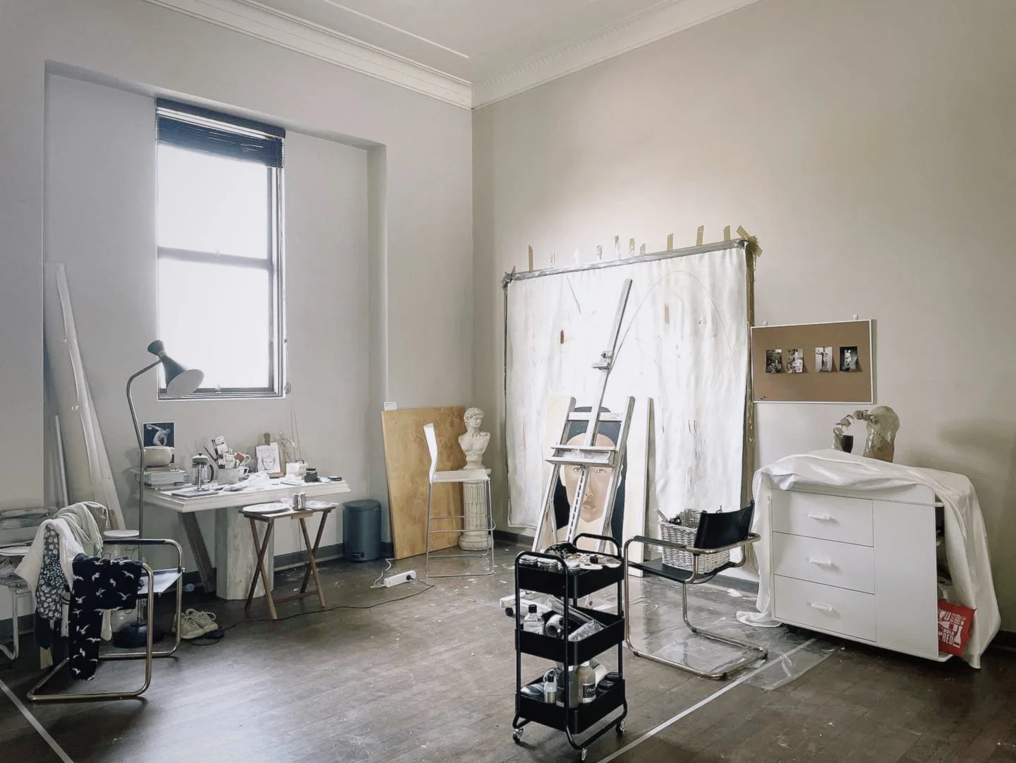 Artist studio for rent with sculptures, easel, and art supplies