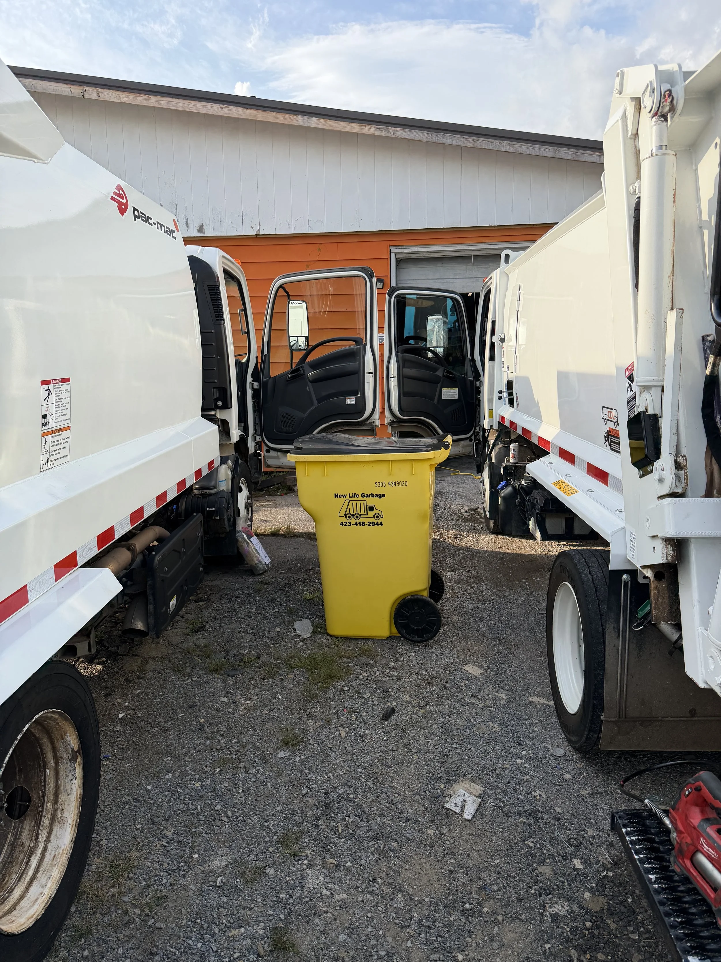 Two New Life Garbage trucks getting cleaned up and refreshed for another day of picking up your trash!