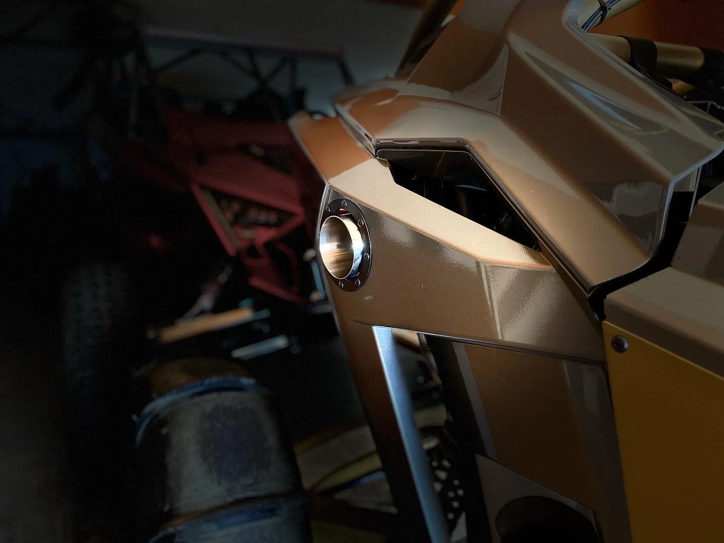Close-up of a starfighter spaceship model with metallic gold and black parts, featuring a circular engine vent.