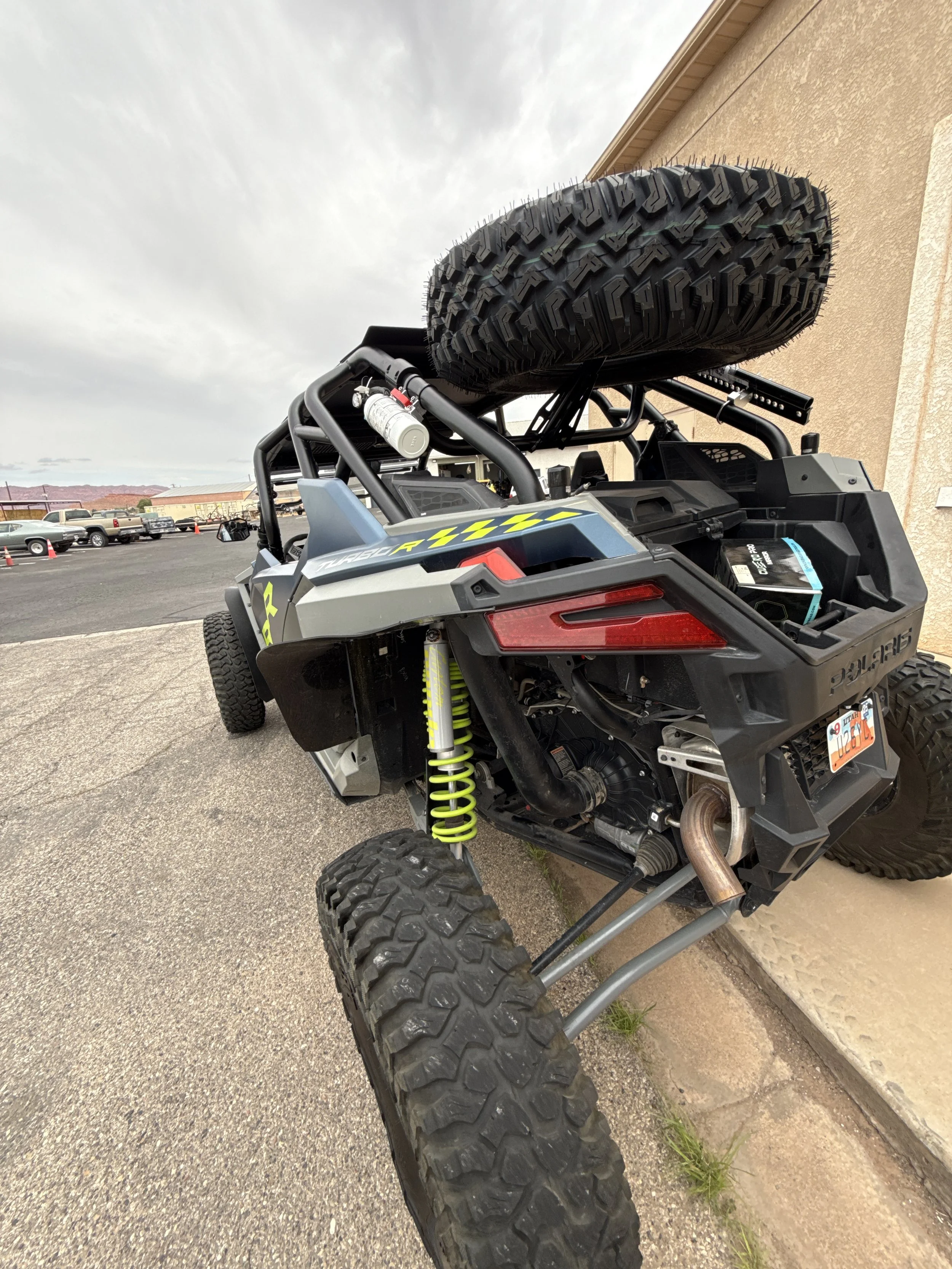 Close-up of a black surface with red and white decal reading 'Custom Shadows motorsports' with a skull logo.