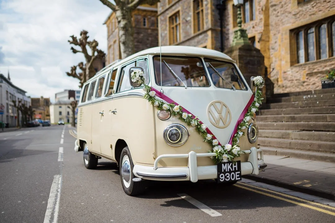 classic splitscreen camper van with flowers for wedding