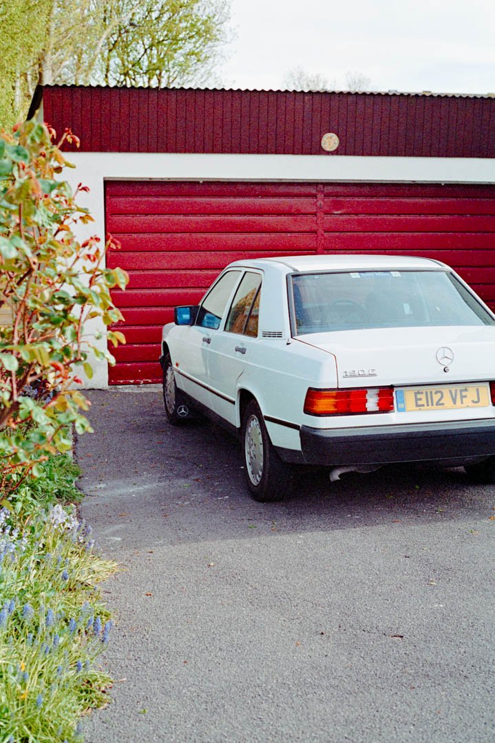 where classic Mercedes car on driveway with red garage, canon a-1