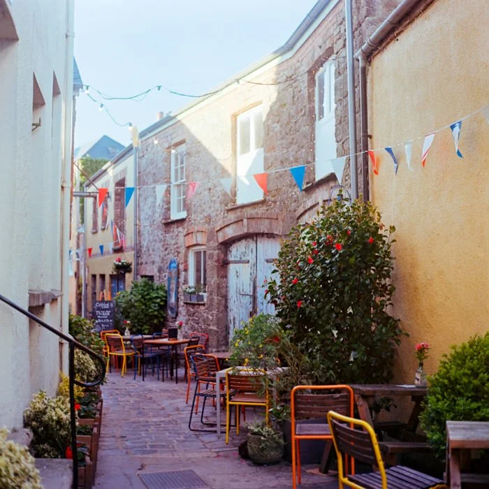 Tenby side street with flags and shops, medium format film 6x6