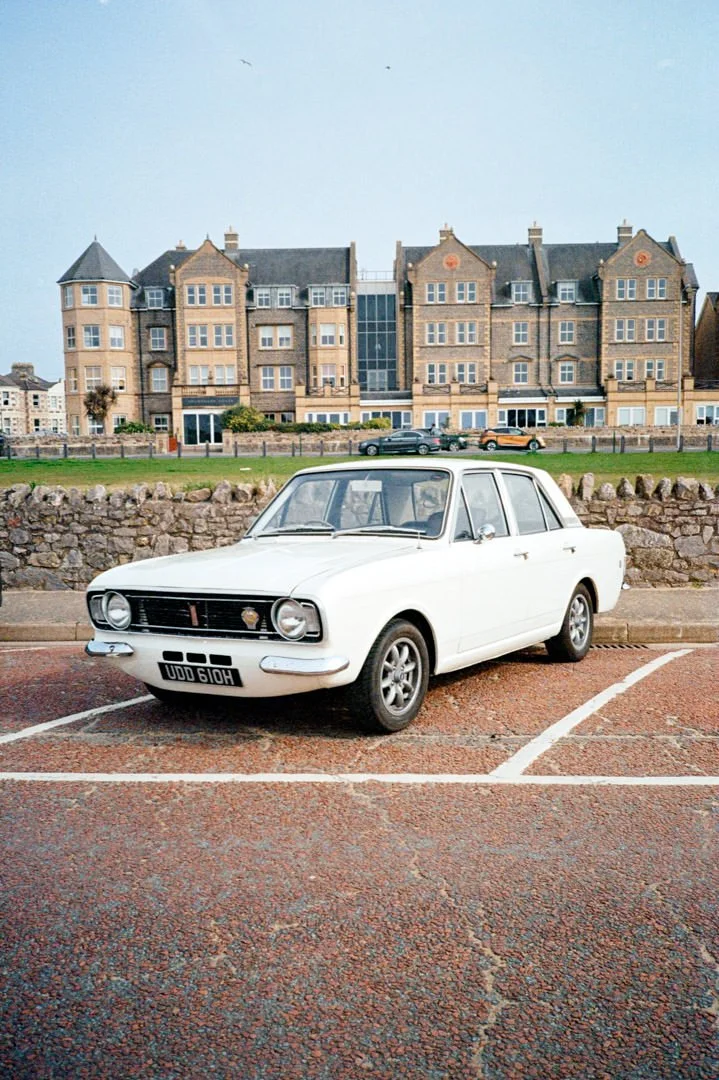 classic ford car parked near green field.