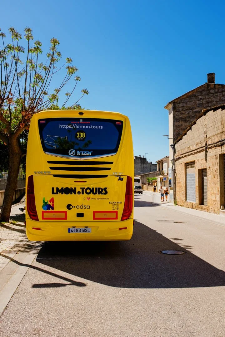 yellow coach parked in street, lemon tours