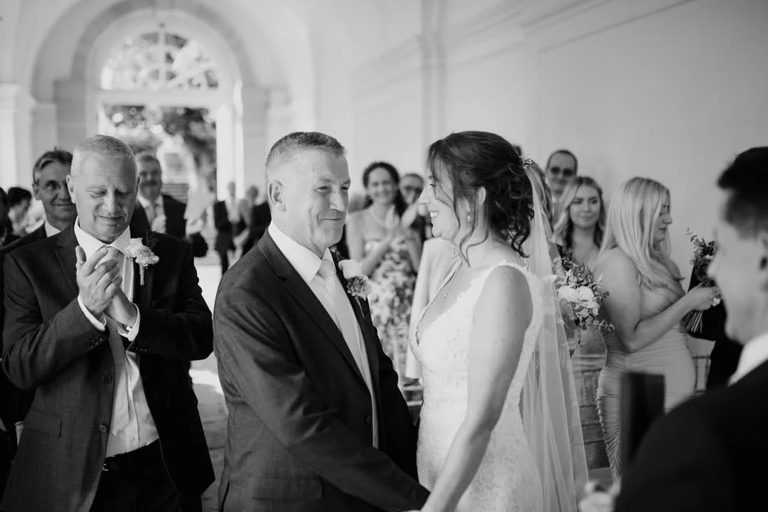 bride and groom with large croud behind them cheering, hestercombe house wedding
