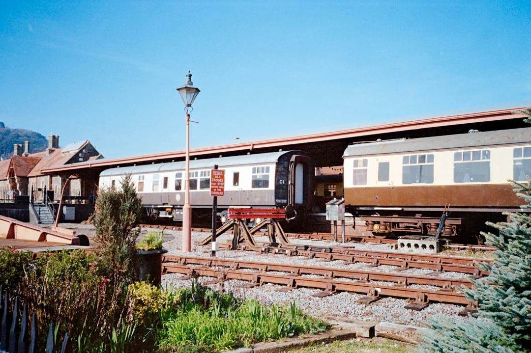 steam trains parked up in railway yard during sunny day