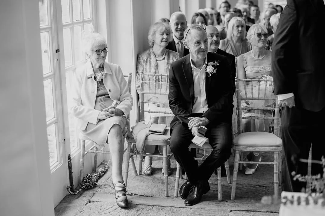 wedding guests sat in large orangery, Hestercombe House wedding