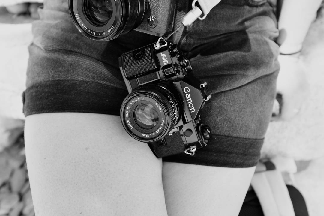 girl with shorts on holding film camera, canon a-1