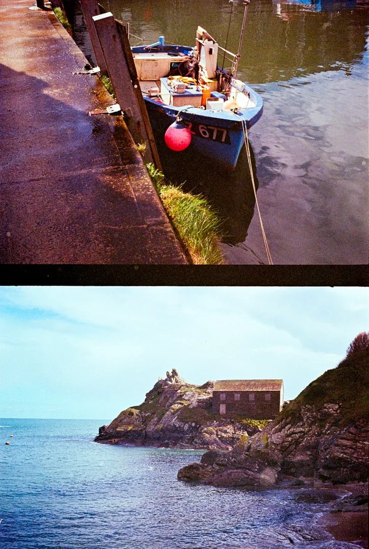 small blue boat with red buoy hanging over the side
