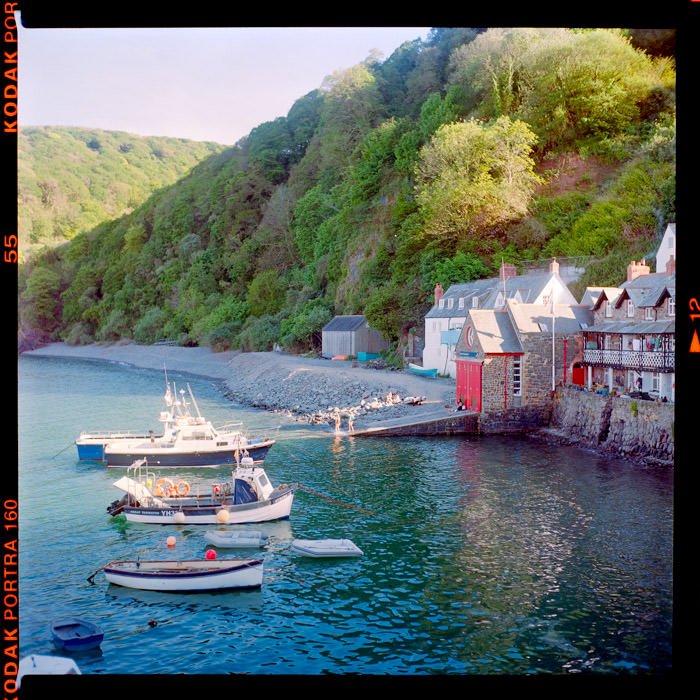 clovelly harbour with boat in the water at sunset