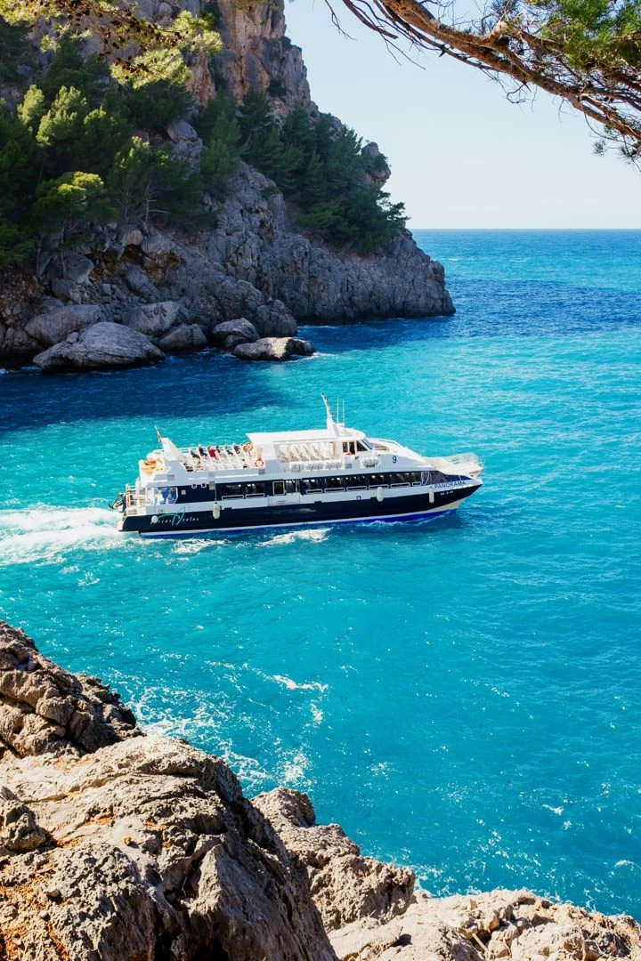 white tourist boat on blue ocean, sa calobra majorca