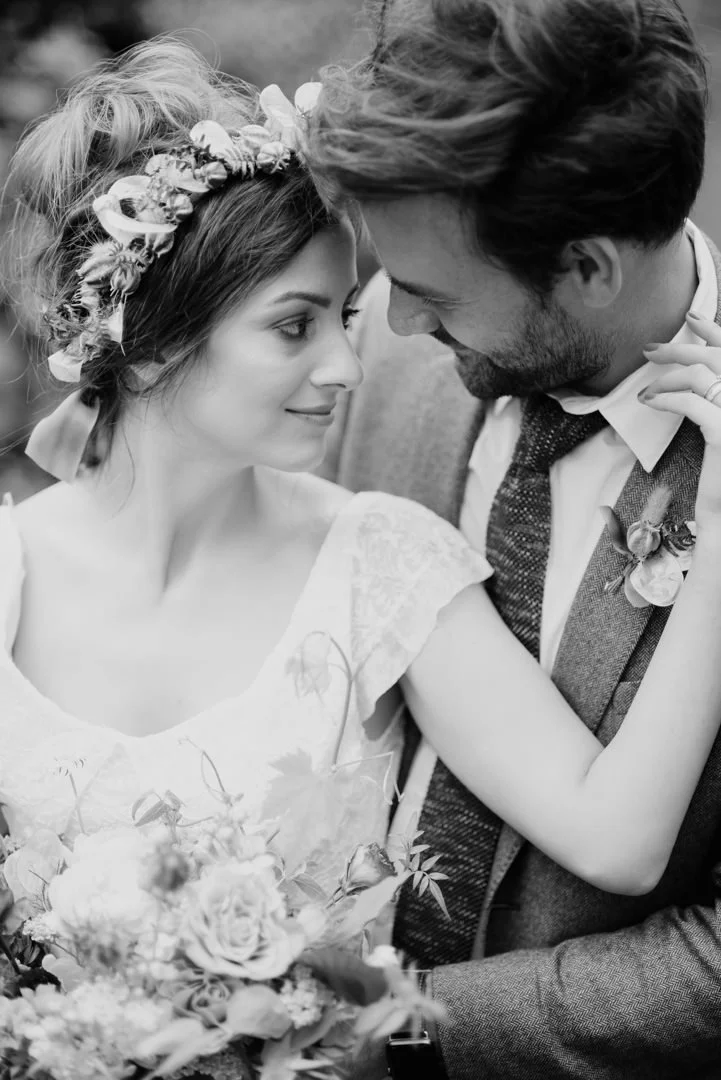 bride holding rustic wedding flowers waring white dress