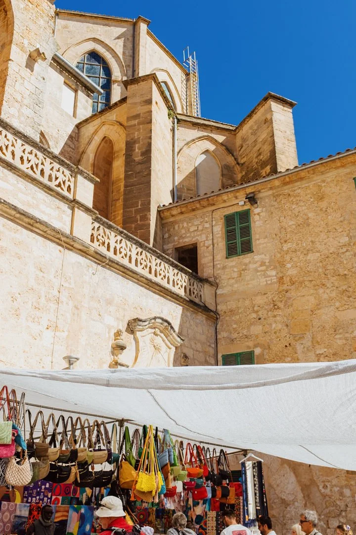 old stone castle with market stalls in the foreground