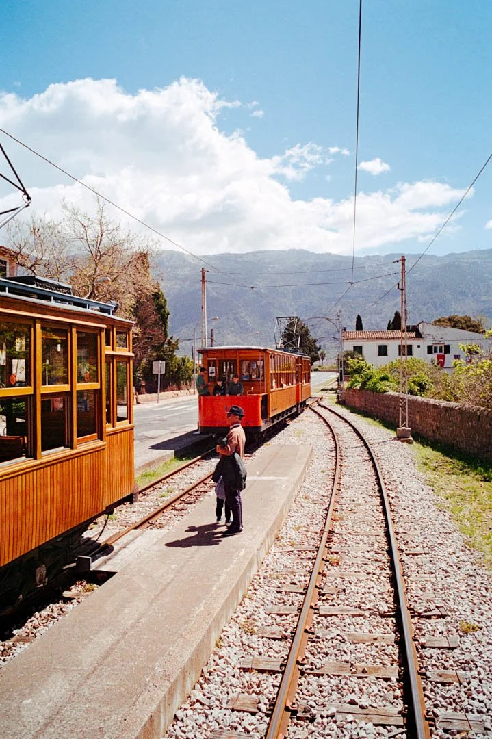 red tram in Soller Majorca. Large mountains in the background