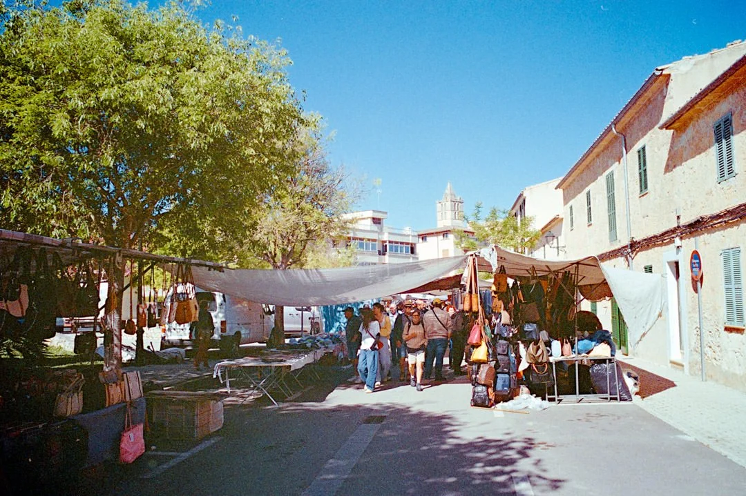 Alcudia market stalls selling clothes and food
