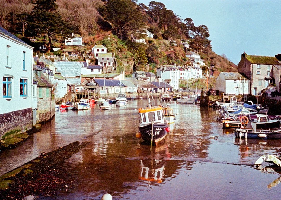polperro fishing harbour with small blue and yellow boat