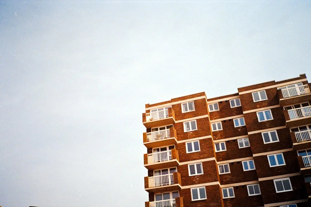 large high rise building with white balconies.