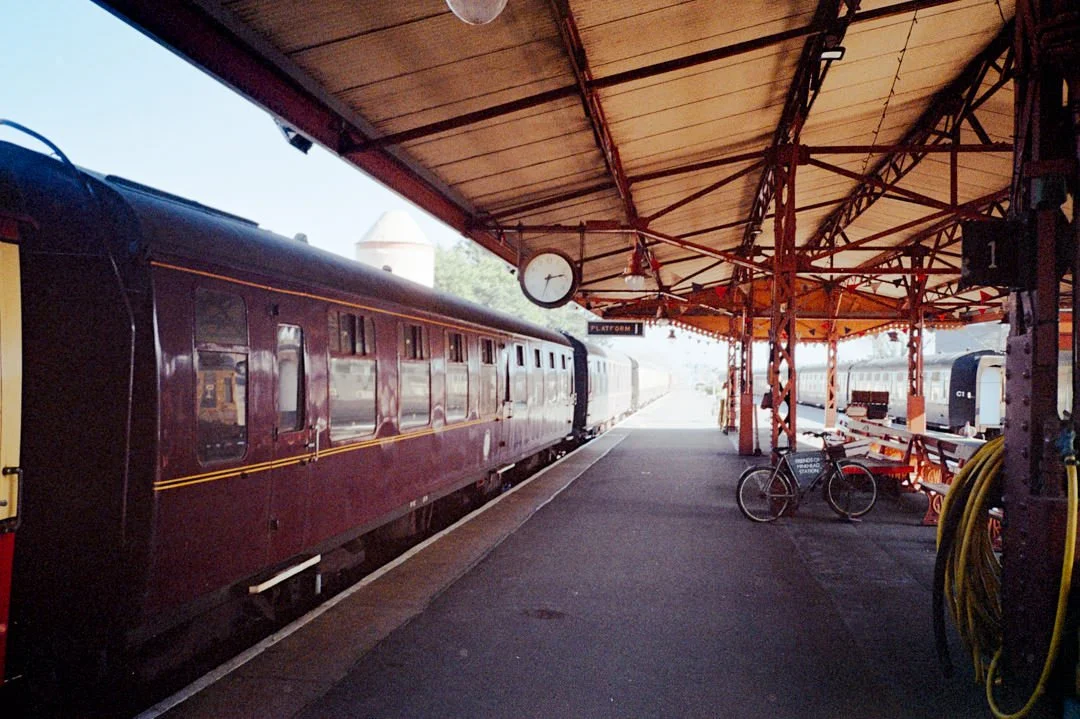 old vintage steam train station during sunny day. there is an old analogue clock in the roof