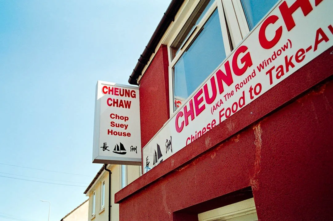 red and white sign above Chinese restaurant, canon a-1