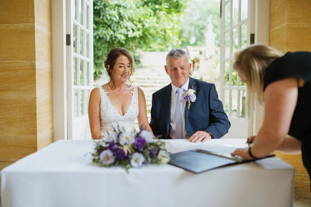 bride and groom signing of the register, Hestercombe House taunton