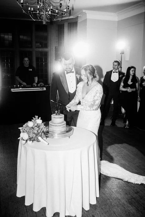 Bride and groom cutting their wedding cake at reception