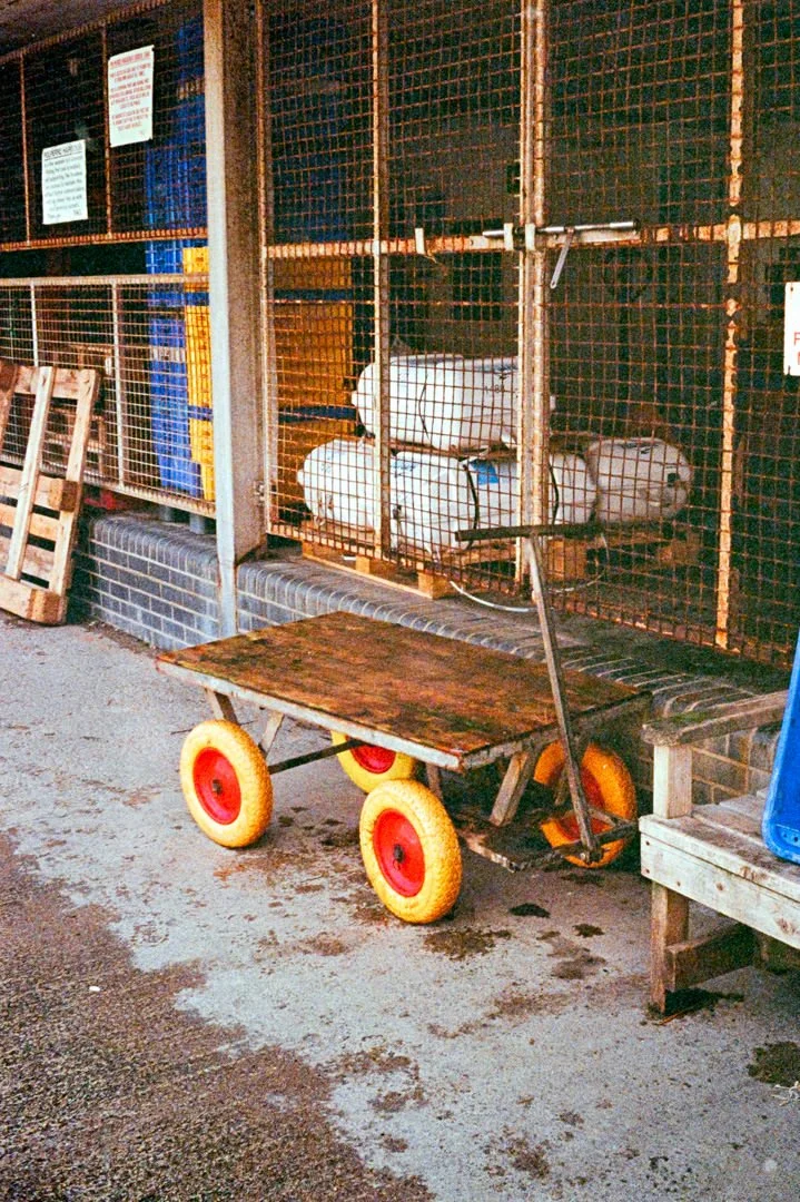 small brown cart with yellow wheels