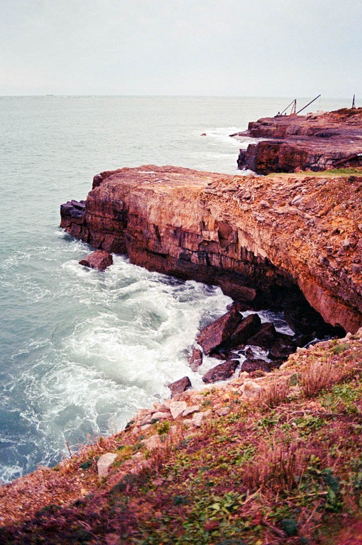 waves crashing against rocks during sunset, Canon A-1