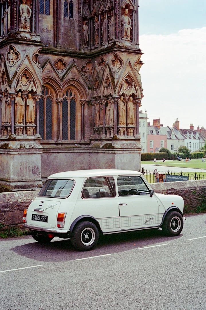 white classic mini car with wide tyres, canon a-1