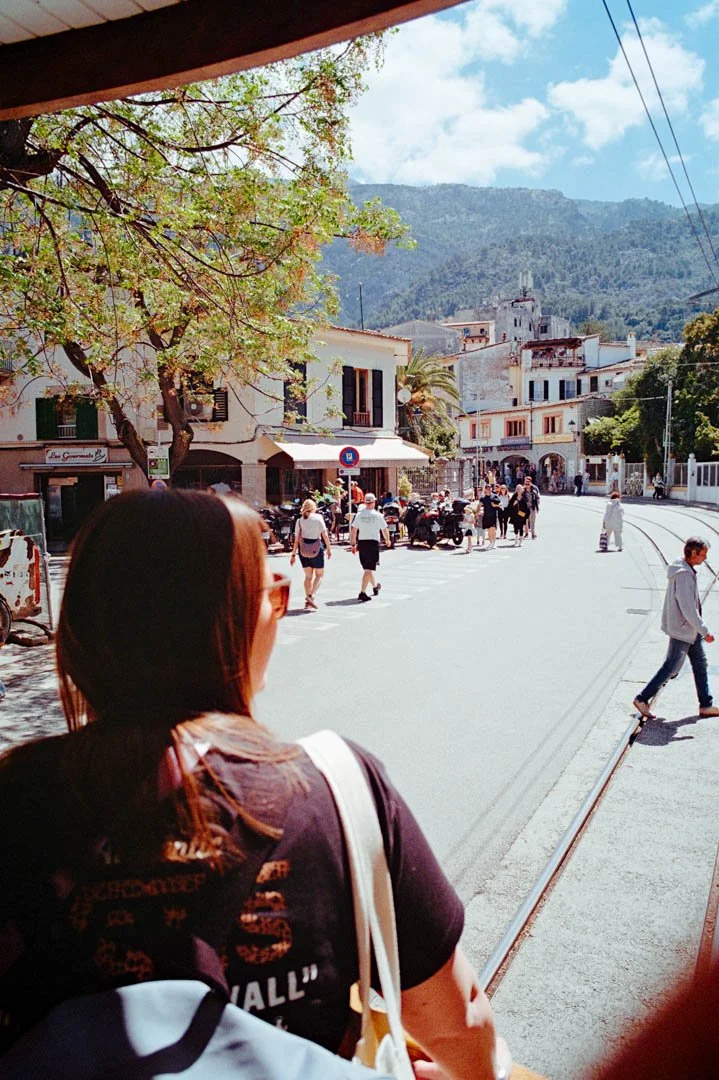Sóller tram with mountains and shops