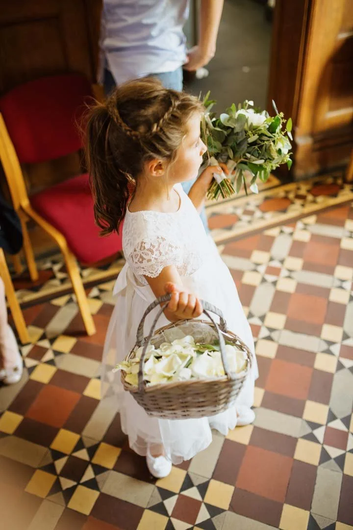 small girl holding a basket of wedding confetti
