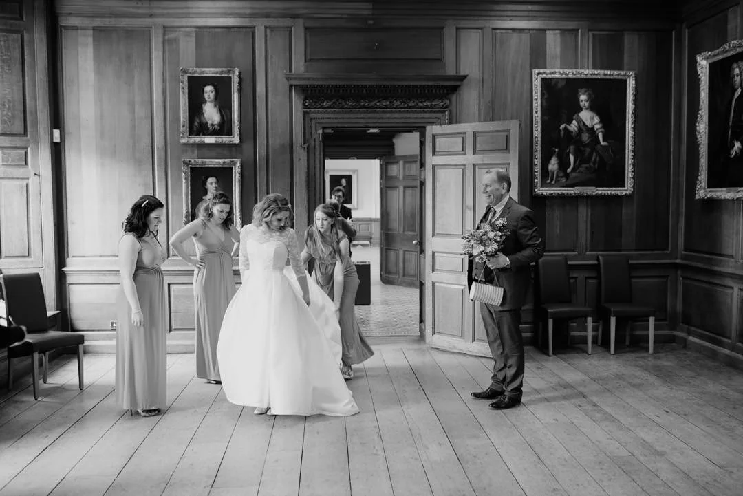 bride and father stood in large room with oil paintings, hestercombe house