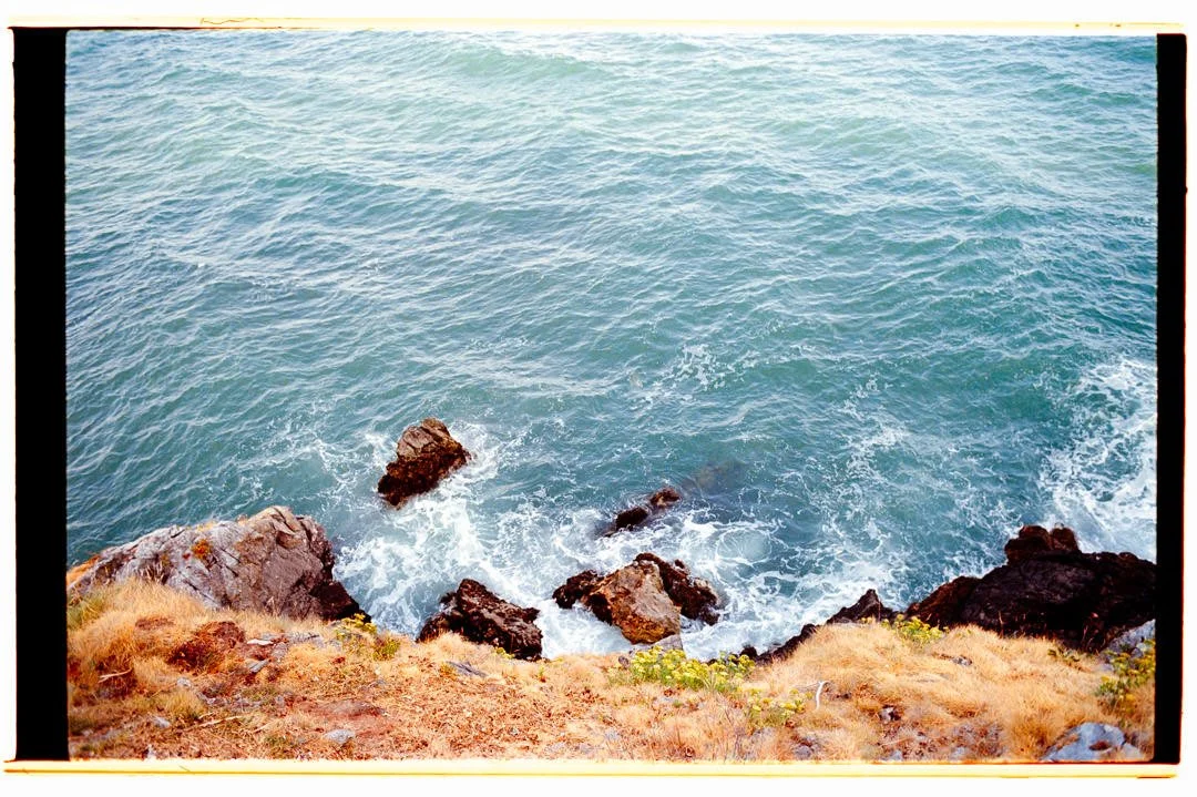 Coastal view of ocean with waves crashing against rocks along the shoreline