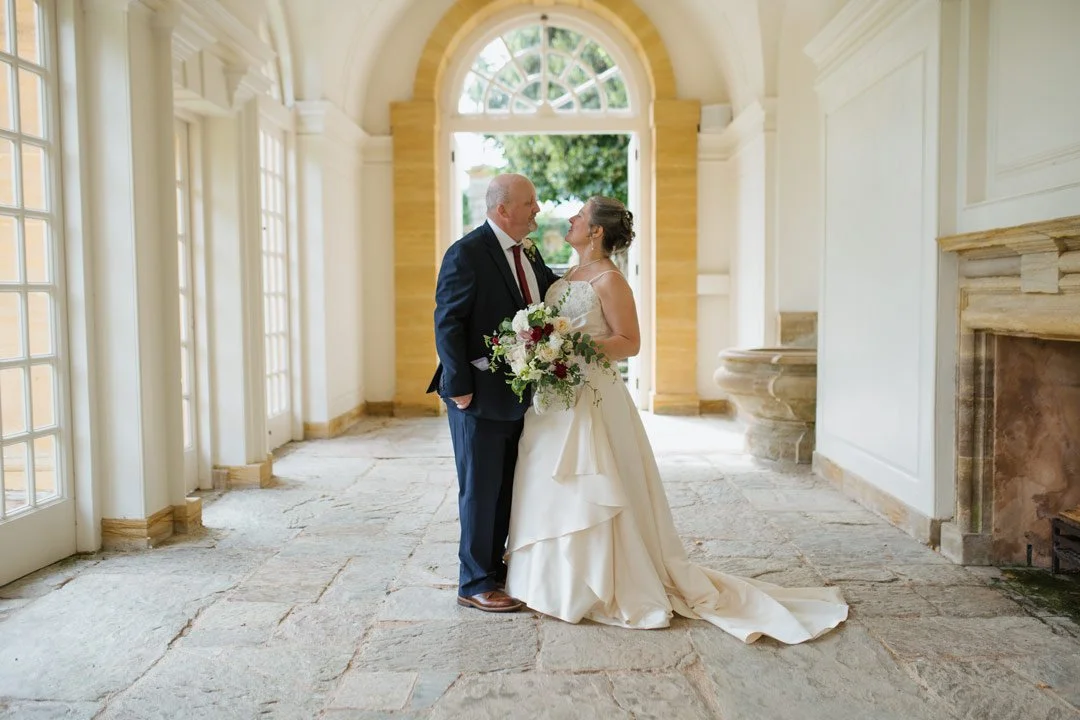 bride and groom stood in large orangery, hestercombe house