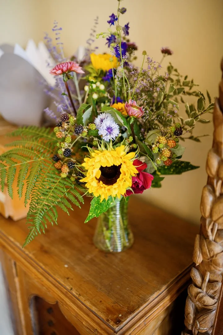 yellow and blue wedding flowers on brown table