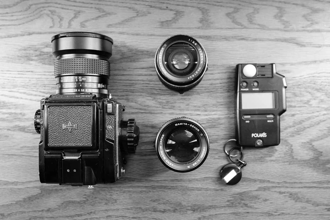 Mamiya 645 with seeker c lenses on wooden table.
