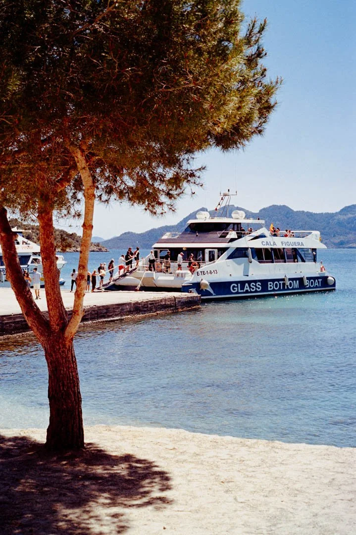 glass bottom boat near beach with clear water, formentor Majorca